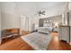 Large bedroom featuring hardwood floors, a ceiling fan, and a stylish area rug at 5002 Davenport Pl, Roswell, GA 30075