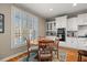 Charming kitchen featuring white cabinets, hardwood floors, and a breakfast nook at 5002 Davenport Pl, Roswell, GA 30075