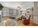 Comfortable living room showcasing plantation shutters, a ceiling fan, and a neutral color palette at 5002 Davenport Pl, Roswell, GA 30075