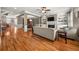 Open-concept living room featuring hardwood floors and a cozy fireplace at 5002 Davenport Pl, Roswell, GA 30075