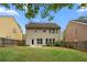 Exterior of home with a grassy backyard, and patio area accessible through the back door at 3119 Devauden Ct, Duluth, GA 30096