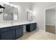Bathroom with double sink vanity, modern mirrors, and access to an adjacent bedroom at 3119 Devauden Ct, Duluth, GA 30096