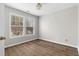 Bedroom with wood flooring and large windows offering abundant natural light at 3119 Devauden Ct, Duluth, GA 30096