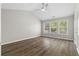 Bright bedroom with hardwood floors, ceiling fan, and windows at 3119 Devauden Ct, Duluth, GA 30096