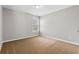Bedroom featuring neutral carpet and a window providing ample natural light at 3119 Devauden Ct, Duluth, GA 30096
