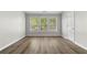 Bright bedroom with hardwood floors and three windows at 3119 Devauden Ct, Duluth, GA 30096