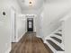 Bright foyer featuring wood-look floors, a staircase, and a glass-paned front door at 3119 Devauden Ct, Duluth, GA 30096