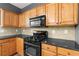 Kitchen featuring black appliances and light wood cabinets at 3119 Devauden Ct, Duluth, GA 30096