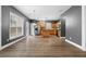 Open-concept view of kitchen with stainless appliances, dark countertops, and light wood cabinets at 3119 Devauden Ct, Duluth, GA 30096