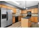Spacious kitchen featuring granite countertops, stainless appliances, a center island, and wooden cabinets at 3119 Devauden Ct, Duluth, GA 30096