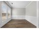 Bright room with wainscoting and large windows offering ample natural light, wood-look flooring at 3119 Devauden Ct, Duluth, GA 30096