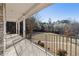Relaxing back porch with metal railings, offering scenic views of the natural landscape at 4741 Covenant Way, Powder Springs, GA 30127