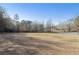 Expansive backyard with a mix of open lawn and wooded areas, offering privacy and space at 4741 Covenant Way, Powder Springs, GA 30127