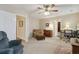 Relaxing bedroom with plush armchair, ceiling fan, neutral walls, and carpet flooring, offering a comfortable retreat at 4741 Covenant Way, Powder Springs, GA 30127