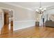 Dining room with hardwood floors and chandelier open to the living area and kitchen at 4741 Covenant Way, Powder Springs, GA 30127