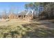 Well-maintained brick home with a manicured lawn and mature trees, offering curb appeal and privacy at 4741 Covenant Way, Powder Springs, GA 30127