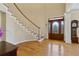 Bright foyer with hardwood floors, a curved staircase, and an ornate front door with sidelights at 4741 Covenant Way, Powder Springs, GA 30127