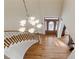 Grand two-story foyer featuring hardwood floors, a chandelier, and a beautiful front door at 4741 Covenant Way, Powder Springs, GA 30127