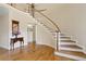 Elegant foyer featuring hardwood floors, a curved staircase, and a view of the upper level at 4741 Covenant Way, Powder Springs, GA 30127