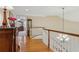Bright hallway with hardwood floors and curved staircase, leading to the home's second level at 4741 Covenant Way, Powder Springs, GA 30127