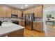 Kitchen featuring stainless steel appliances, light wood cabinets, and hardwood floors at 4741 Covenant Way, Powder Springs, GA 30127