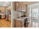 Convenient kitchen and desk area with light wood cabinets and lots of natural light at 4741 Covenant Way, Powder Springs, GA 30127