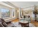 Well-lit living room with large bay window, hardwood floors, and comfortable furniture at 4741 Covenant Way, Powder Springs, GA 30127