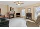 Cozy living room featuring a fireplace, plush carpeting, and natural light from the windows at 4741 Covenant Way, Powder Springs, GA 30127
