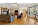 Expansive living room with fireplace, hardwood floors, and lots of windows looking into the backyard at 4741 Covenant Way, Powder Springs, GA 30127