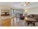 Open living room features hardwood floors, and many windows for ample light and comfortable seating at 4741 Covenant Way, Powder Springs, GA 30127