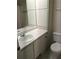 White bathroom with a single sink vanity, built-in storage, and a black and white tile floor at 524 Northridge Crossing Dr, Atlanta, GA 30350