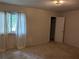 Bedroom featuring neutral walls, wall-to-wall carpet, and a single window with white curtains at 524 Northridge Crossing Dr, Atlanta, GA 30350