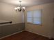 Simple dining room area featuring hardwood floors, window and chandelier at 524 Northridge Crossing Dr, Atlanta, GA 30350