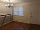 Simple dining room area featuring hardwood floors, a window, and a chandelier at 524 Northridge Crossing Dr, Atlanta, GA 30350