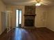 Living room featuring hardwood floors, a stone fireplace, and sliding glass doors at 524 Northridge Crossing Dr, Atlanta, GA 30350