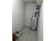 Utility room featuring a hot water heater and tile floor at 524 Northridge Crossing Dr, Atlanta, GA 30350