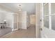 Bright entryway featuring beige colored tile flooring, white molding, and an open view to the office at 103 Eubanks Ct, Woodstock, GA 30188