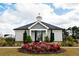 Community clubhouse with manicured landscaping and vibrant flower beds at 1277 Sunny Lake Dr, Lawrenceville, GA 30043