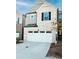 Charming townhouse featuring a white brick facade and a two-car garage at 1277 Sunny Lake Dr, Lawrenceville, GA 30043