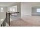 Upstairs hallway featuring decorative railing, carpet, and natural light at 173 Haverling Pass, Hampton, GA 30228