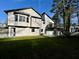 Rear exterior of the home featuring a spacious deck and large backyard with lush greenery at 295 Lamden Ct, Lawrenceville, GA 30046