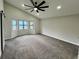 Spacious bedroom with large windows, carpet flooring, and modern ceiling fan at 295 Lamden Ct, Lawrenceville, GA 30046