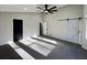 Large bedroom with carpet floors, barn door, and natural lighting from a large window at 295 Lamden Ct, Lawrenceville, GA 30046