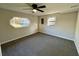 Carpeted bedroom featuring a ceiling fan and a large window at 295 Lamden Ct, Lawrenceville, GA 30046