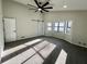Large bedroom with natural lighting from a bay window, carpet floors, and a barn door at 295 Lamden Ct, Lawrenceville, GA 30046