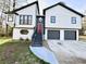 Charming two-story home boasts a modern exterior with a well-manicured lawn and a convenient two-car garage at 295 Lamden Ct, Lawrenceville, GA 30046