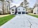 Charming two-story home with a well-maintained lawn and a double garage at 295 Lamden Ct, Lawrenceville, GA 30046