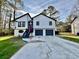 Beautiful modern home boasts eye-catching curb appeal with a two-car garage and inviting entrance at 295 Lamden Ct, Lawrenceville, GA 30046