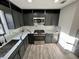 Modern kitchen with grey cabinets, stainless steel appliances, and marble countertops at 295 Lamden Ct, Lawrenceville, GA 30046