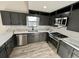 Modern kitchen with grey cabinets, stainless steel appliances, and marble countertops at 295 Lamden Ct, Lawrenceville, GA 30046